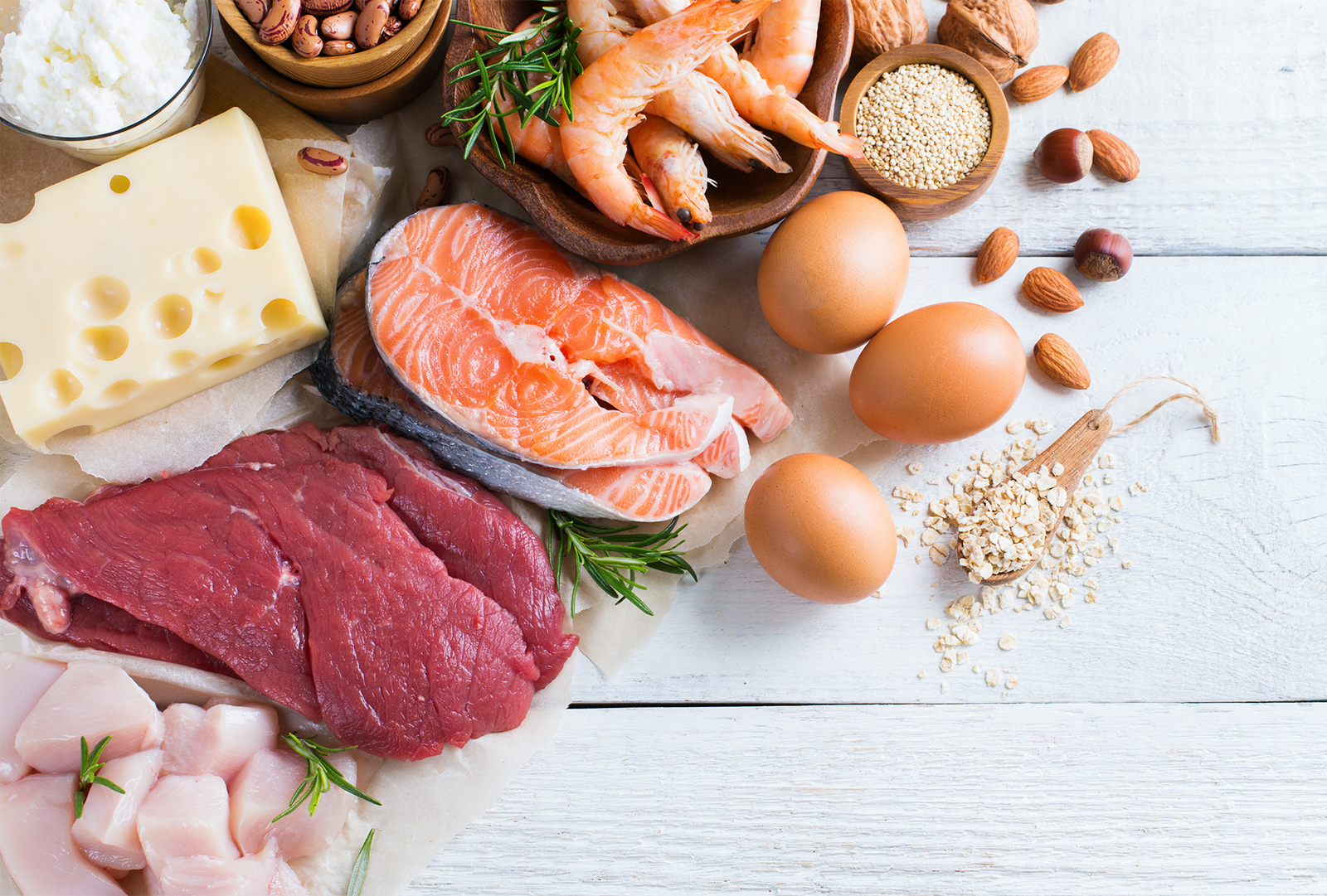 Fresh ingredients and raw meats arranged on a table